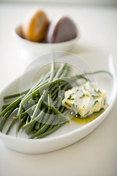 Fresh and delicious Haricots Verts (French Green Beans) with Herb Butter on a plate photo