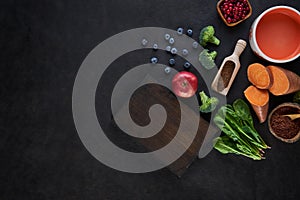 Fresh delicious ingredients for healthy cooking on rustic background, top view, food concept.