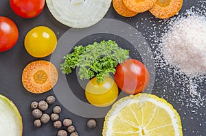 Fresh delicious ingredients for healthy cooking or salad making on dark black background.Top view, banner