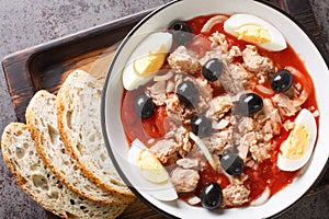 Fresh and delicious Murcian moje traditional salad with canned tomatoes, tuna, eggs and onions topped with virgin olive oil