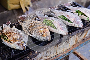 Fresh delicious Salt Crusted Grilled Fish in street market