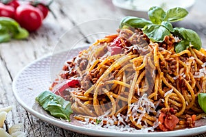 Fresh and delicious spagetti bolognese on wooden table.