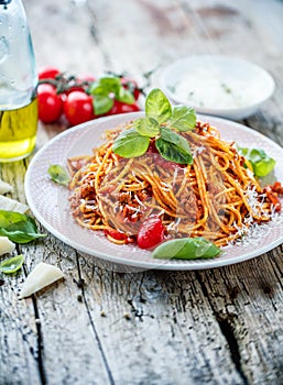 Fresh and delicious spagetti bolognese on wooden table.