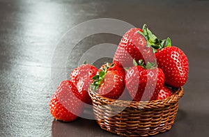 Fresh  delicious strawberries in a basket on table