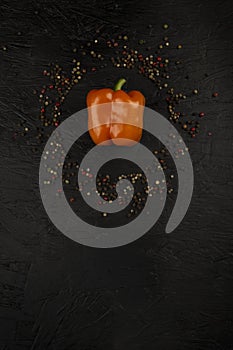fresh and delicious, yellow, red and orange peppers on black background