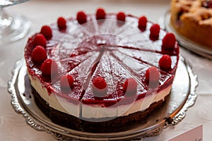 Fresh dessert fruit cake covered in raspberries ( Snowwhite cake