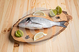 Fresh dorada on wooden cutting board