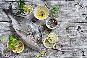 Fresh Dorado fish, lemon, lime and parsley photo