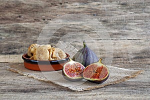 Fresh and dried figs on wood