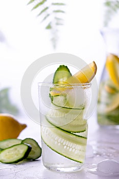 Fresh drink with cucumber, lemon and rosemary herb. Cold summer lemonade. On white background