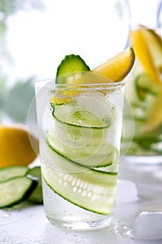 Fresh drink with cucumber, lemon and rosemary herb. Cold summer lemonade. On white background