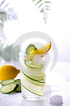 Fresh drink with cucumber, lemon and rosemary herb. Cold summer lemonade. On white background