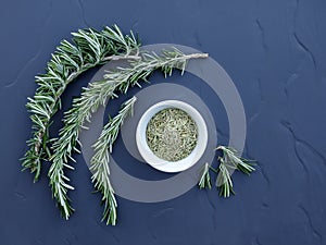 Fresh and dry rosemary on the table