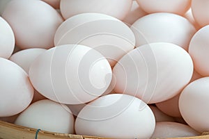 Fresh duck eggs in bamboo basket.