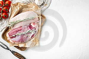 Fresh duck meat for food, Raw duck breast , with herbs and ingredients, on wooden tray, on white stone  background, top view flat