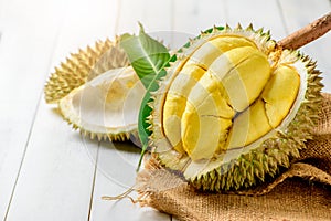 Fresh durian Kan yao or Durio zibthinus Murray on sack and old wood background