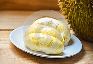 Fresh durian peel tropical fruit summer on white plate on wooden background