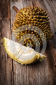 Fresh Durian on wooden background. Still life with dark vignette. Tropical fruit. King of fruit. Monthong breed.