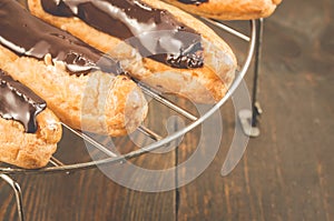 Fresh eclairs on a wooden table/fresh eclairs on a wooden table.