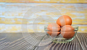 Fresh egg glass bowl on the wooden table background - Raw chicken eggs collect from the farm products natural eggs for food