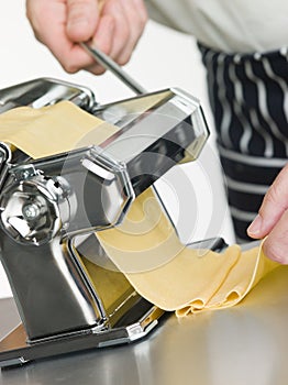 Fresh Egg Pasta being rolled in a Pasta Machine