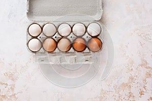 Fresh eggs arranged in a color gradient in an egg box