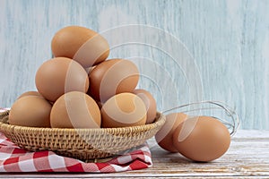 The Fresh eggs in a basket on wooden table