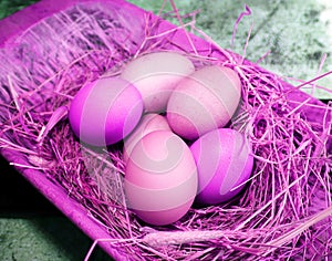 Fresh eggs laying in  hye in an old vintage antique wooden tray