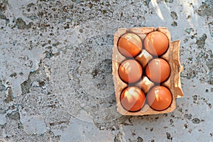 Fresh Eggs in paper brown box on a rustic background
