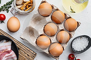 Fresh eggs on paper egg box  on white background  top view flat lay