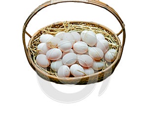 Fresh eggs in a rice straw basket isolated on white background