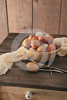 Fresh eggs on rustic wooden table