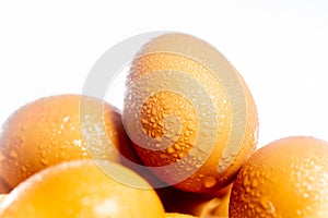 Fresh eggs with water condensation in a rattan basket. Isolated on white. Shallow depth of field