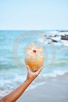 Fresh Exotic Coconut Water Drink in Woman Hand