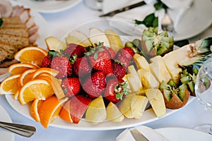 Fresh, exotic, organic fruits, light snacks in a plate on a buffet table. Assorted mini delicacies and snacks, restaurant food at