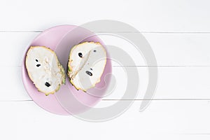 Fresh exotic tropical fruit. Two halfs of custard apple isolated on white background, annona cherimoya.