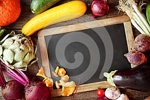 Fresh fall cooking ingredients around a slate