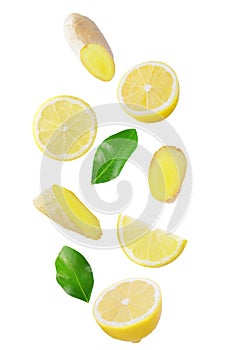 Fresh falling lemon and ginger isolated on white photo