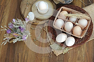 Fresh farm eggs in basket on a wooden background