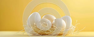 Fresh farm eggs nestled in straw on a subtle yellow background