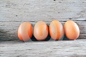 Fresh farm eggs on a wooden rustic background.