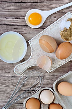 Fresh farm eggs on a wooden rustic background.