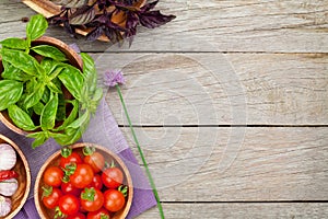 Fresh farmers tomatoes and basil on wood table