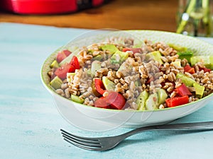 Fresh farro spelt salad with tomatoes, avocado