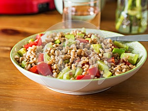 Fresh farro spelt salad with tomatoes, avocado