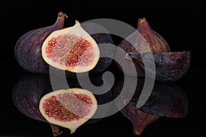 Fresh fig fruit isolated on black glass