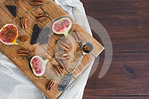 Fresh figs and pekan nuts with honey on a wooden board photo