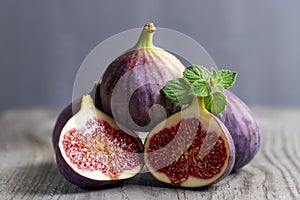 Fresh figs on the wooden table with mint leaves