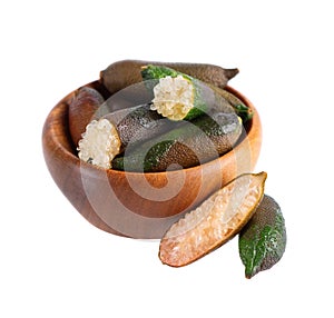 Fresh finger limes in wooden bowl isolated on white background. Caviar lime. Fruits pods.