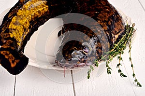 Fresh fish burbot on white plate, close up, white background